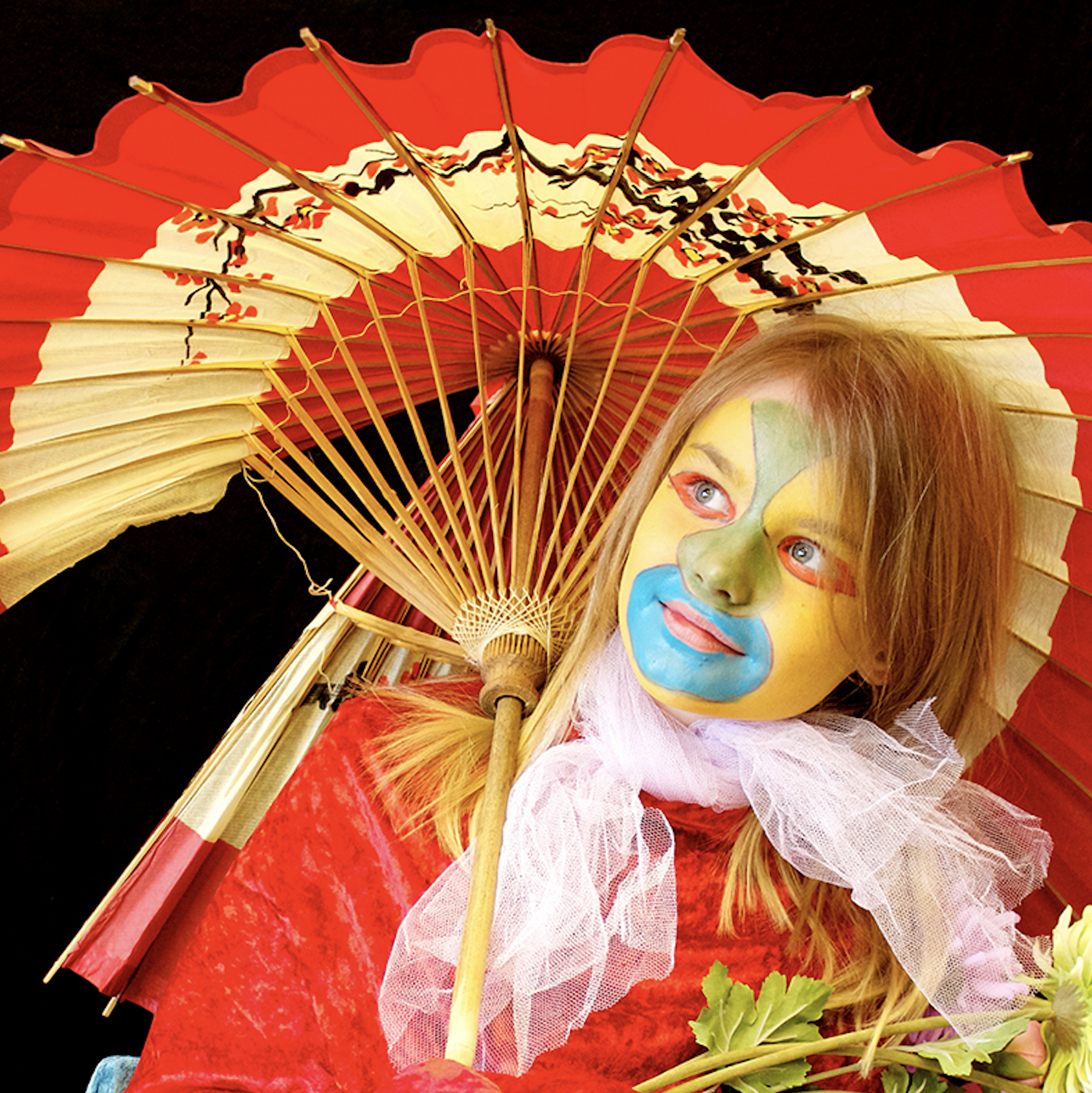 A girl with face paint and an umbrella