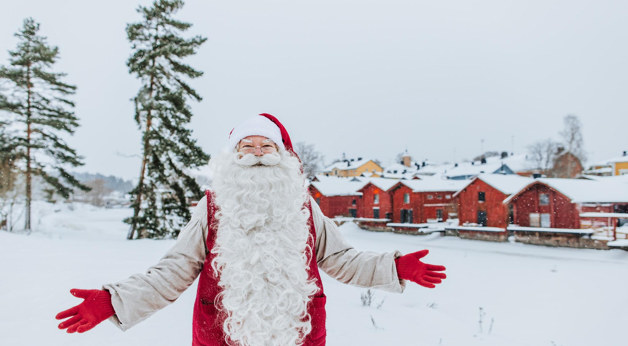 Santa Claus and the red ochre shore houses in Porvoo